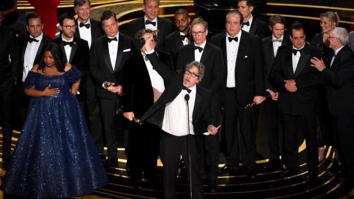 Peter Farrelly, center, and the cast and crew of "Green Book" accept the award for best picture at the Oscars on Feb. 24.