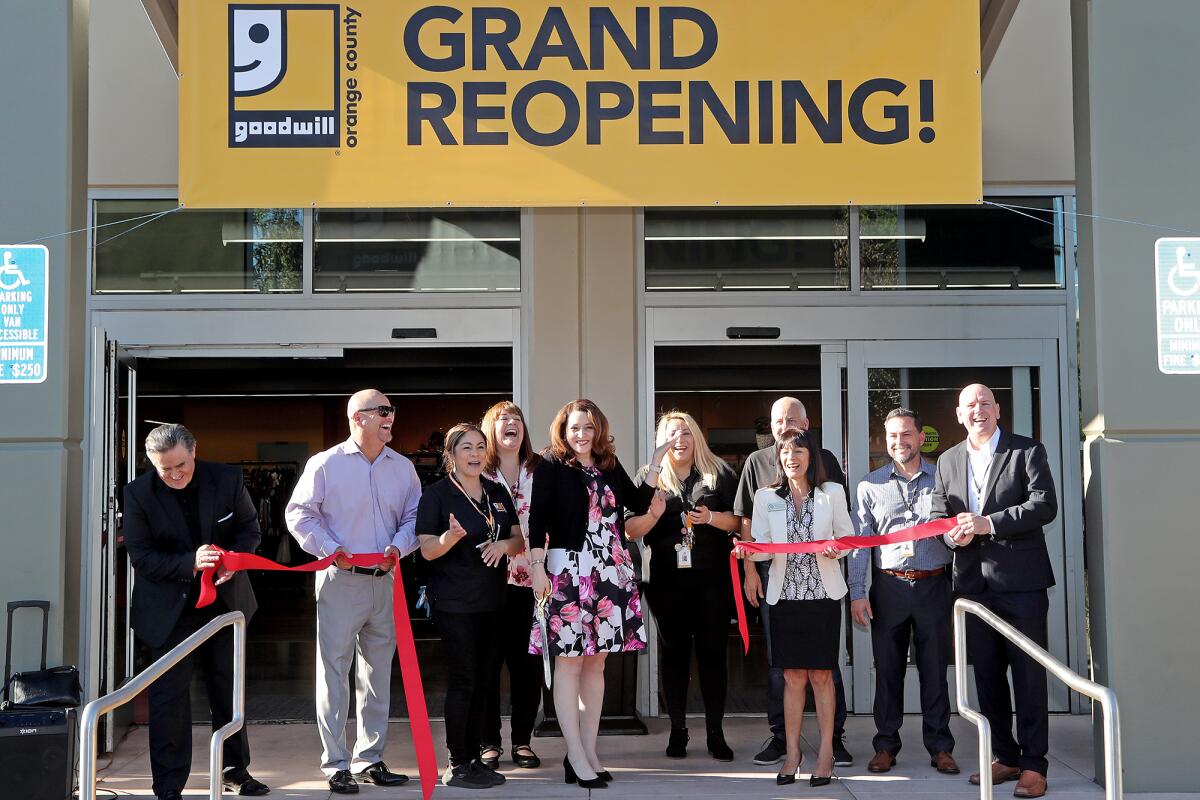 Nicole Suydam cuts the ceremonial ribbon during the grand reopening of Goodwill Orange County in Santa Ana.