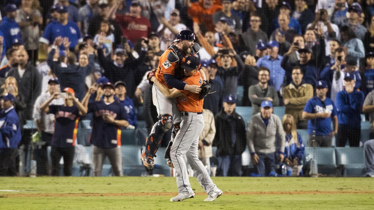 Astros players begin to celebrate after recording the final out in Game 7.