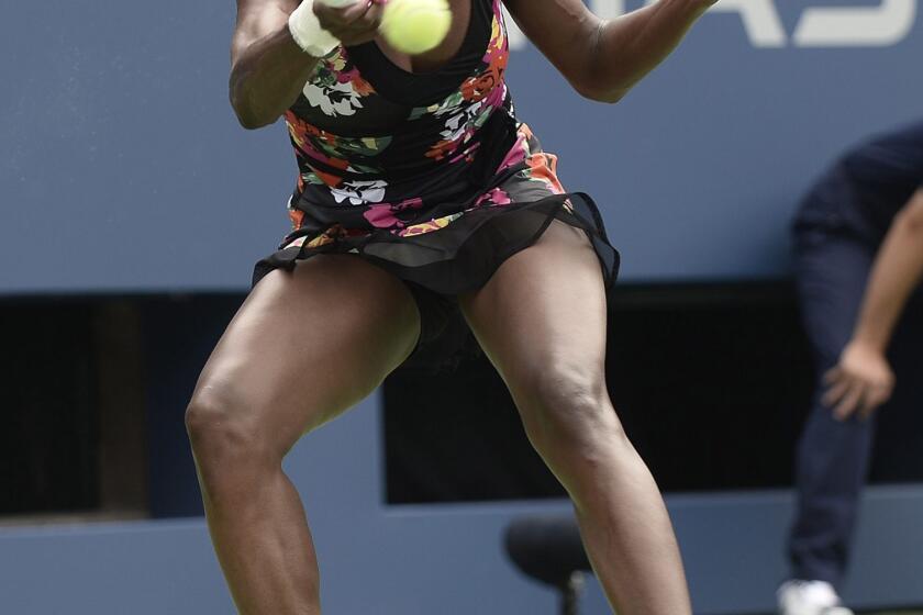 Venus Williams returns a shot during her first-round victory over Kirsten Flipkens at the U.S. Open on Monday.