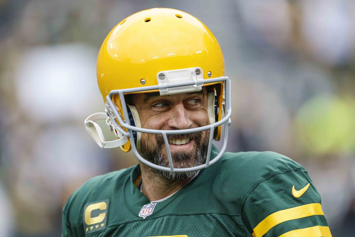 Aaron Rodgers smiles in a Green Bay uniform.
