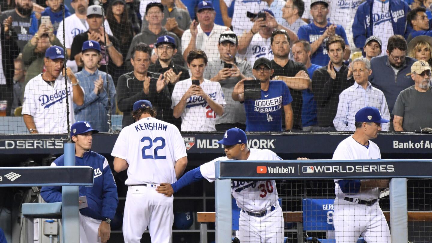 Clayton Kershaw gets a pat from manager Dave Roberts after giving up four runs and seven hits in Game 5 of the 2018 World Series.