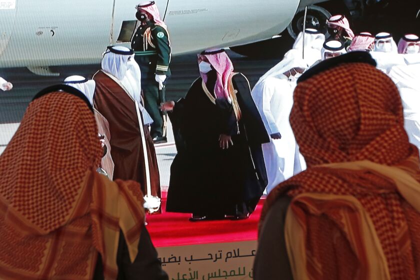Saudi Crown Prince Mohammed bin Salman, center right, greets the Emir of Qatar Sheikh Tamim bin Hamad Al Thani, as he arrives at Al Ula airport, where the 41st Gulf Cooperation Council (GCC) take place in Saudi Arabia, Tuesday, Jan. 5, 2021. Al Thani's arrival in the kingdom’s ancient desert city of Al-Ula on Tuesday was broadcast live on Saudi TV. He was seen descending from his plane and being greeted with a hug by the Saudi crown prince. The diplomatic breakthrough comes after a final push by the outgoing Trump administration and fellow Gulf state Kuwait to mediate an end to the crisis. (AP Photo/Amr Nabil)