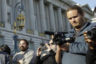 FILE - David DePape, right, records the nude wedding of Gypsy Taub outside City Hall on Dec. 19, 2013, in San Francisco. DePape, who is already in custody in last month's attack on Paul Pelosi, husband of U.S. House Speaker Nancy Pelosi, was indicted Wednesday, Nov. 9, 2022, by a federal grand jury on charges of assault and attempted kidnapping. (AP Photo/Eric Risberg, File)