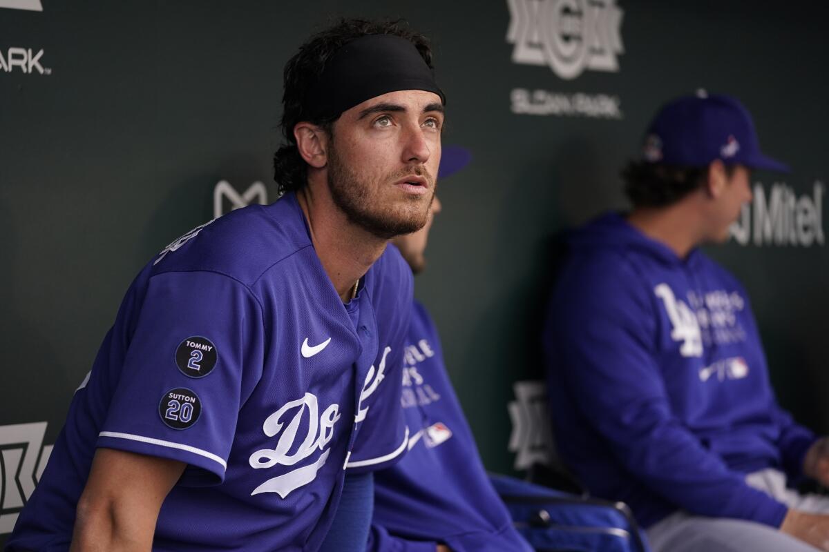 Dodgers center fielder Cody Bellinger sits in the dugout before a spring training baseball game against the Chicago Cubs.