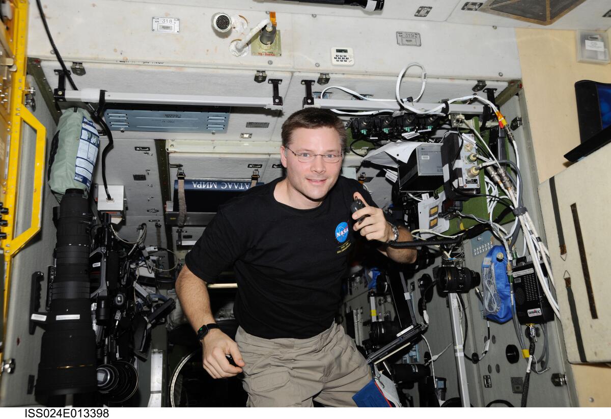 NASA astronaut Doug Wheelock, uses a ham radio system in the Zvezda Service Module of the International Space Station.