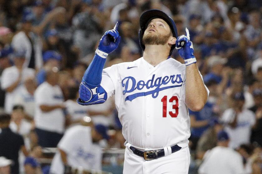 Los Angeles Dodgers third baseman Max Muncy celebrates while crossing home after a solo home run