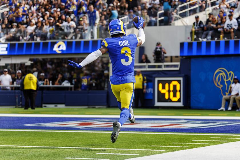 The Rams' Kamren Curl (3) skips into the end zone after returning a fumble 33 yards for a touchdown against the Raiders.