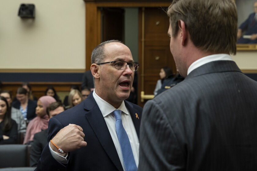 Fred Guttenberg, left, whose daughter was killed in the Parkland, Fla., school shooting, talks with Rep. Eric Swalwell, D-Calif., before FBI Director Christopher Wray testifies during an oversight hearing of the House Judiciary Committee, on Capitol Hill, Wednesday, Feb. 5, 2020 in Washington. (AP Photo/Alex Brandon)