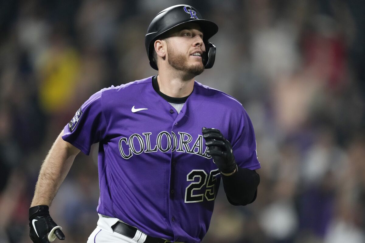 Colorado Rockies' C.J. Cron smiles as he circles the bases after hitting a walkoff solo home run off San Diego Padres relief pitcher Daniel Hudson in the ninth inning of a baseball game on Monday, Aug. 16, 2021, in Denver. (AP Photo/David Zalubowski)
