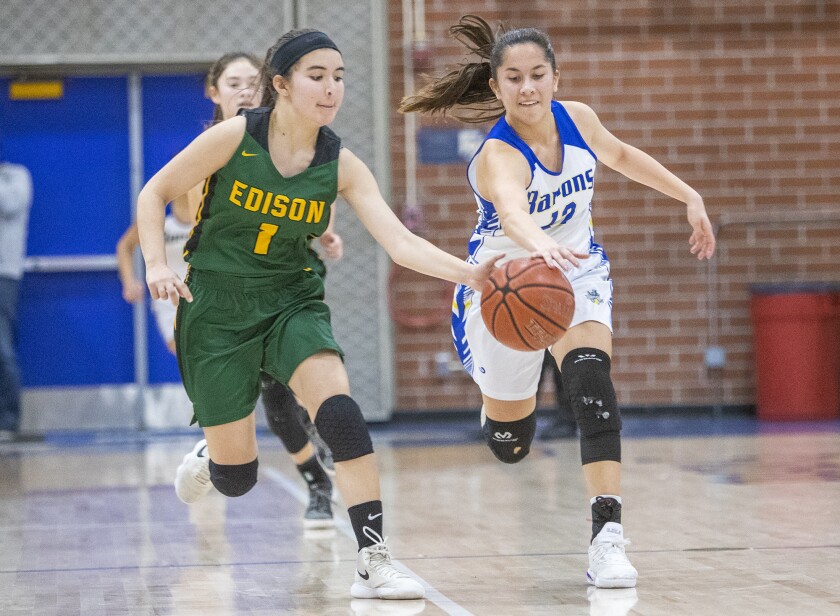 Edison's Noelle Duffey and Fountain Valley's Margaret Tengan battle for a loose ball.