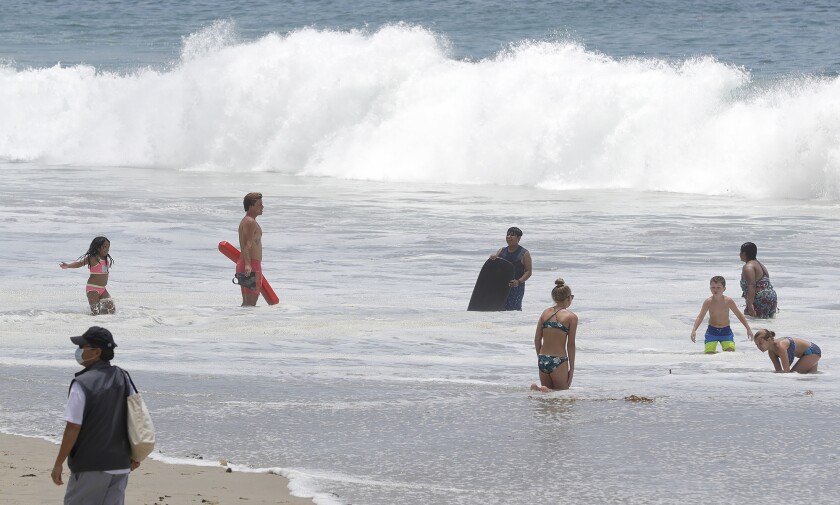 A guard watches a busy scene at Main Beach.