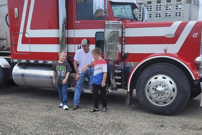 FILE - This undated family photo shows David Schultz with his two sons. The body of an Iowa trucker who went missing just before Thanksgiving has been found, according to his wife. The Iowa Department of Public Safety said Wednesday, April 25, 2024, that a body was found in a farm field near where David Schultz's semi was found parking on a two-lane highway. (Family photo via AP)