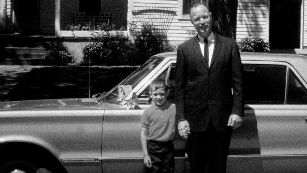 Ray Alkofer, 38, holds the hand of his son Bill, 5, in 1967.