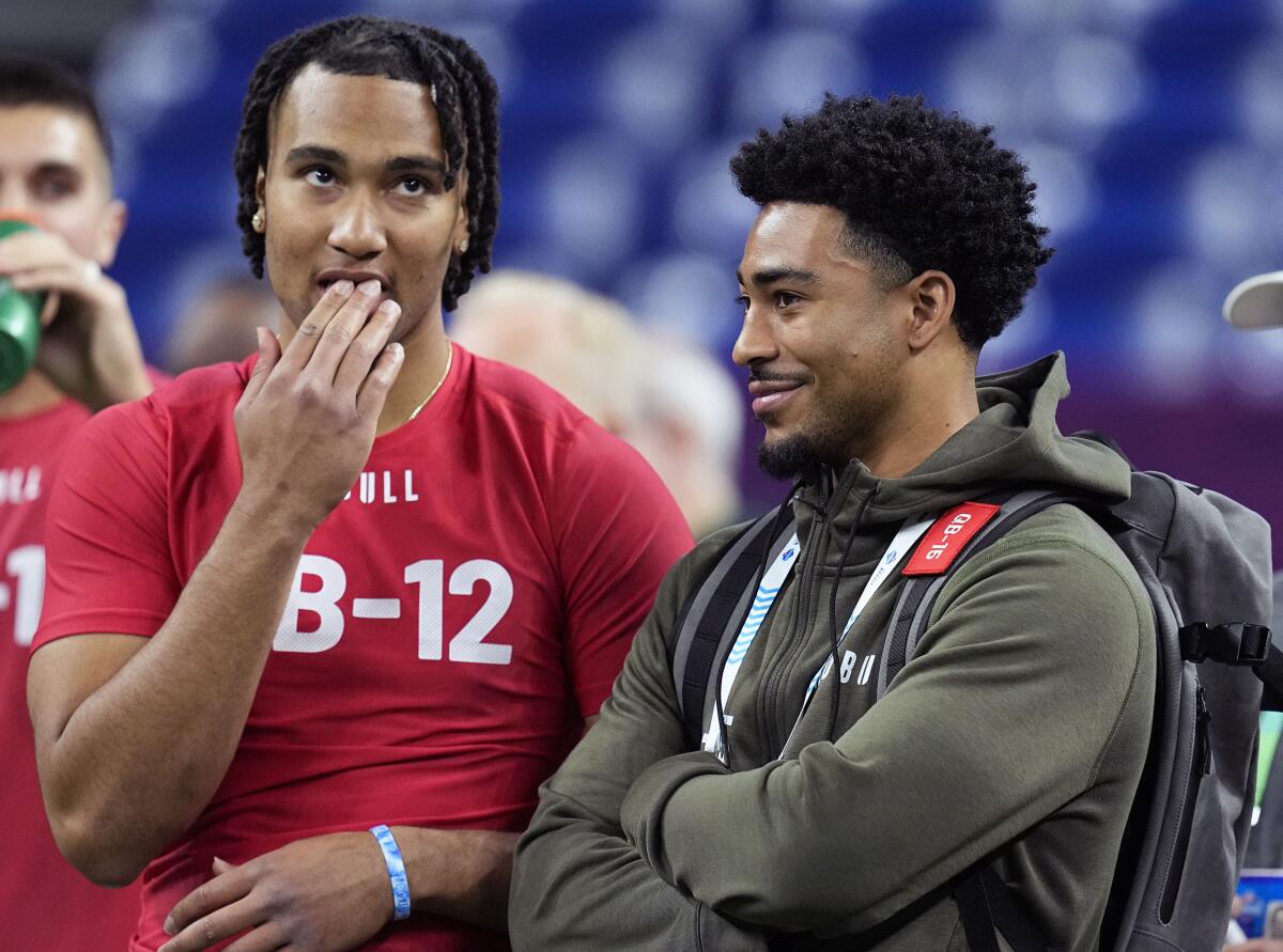 Ohio State quarterback CJ Stroud, left, talks to Alabama quarterback Bryce Young.