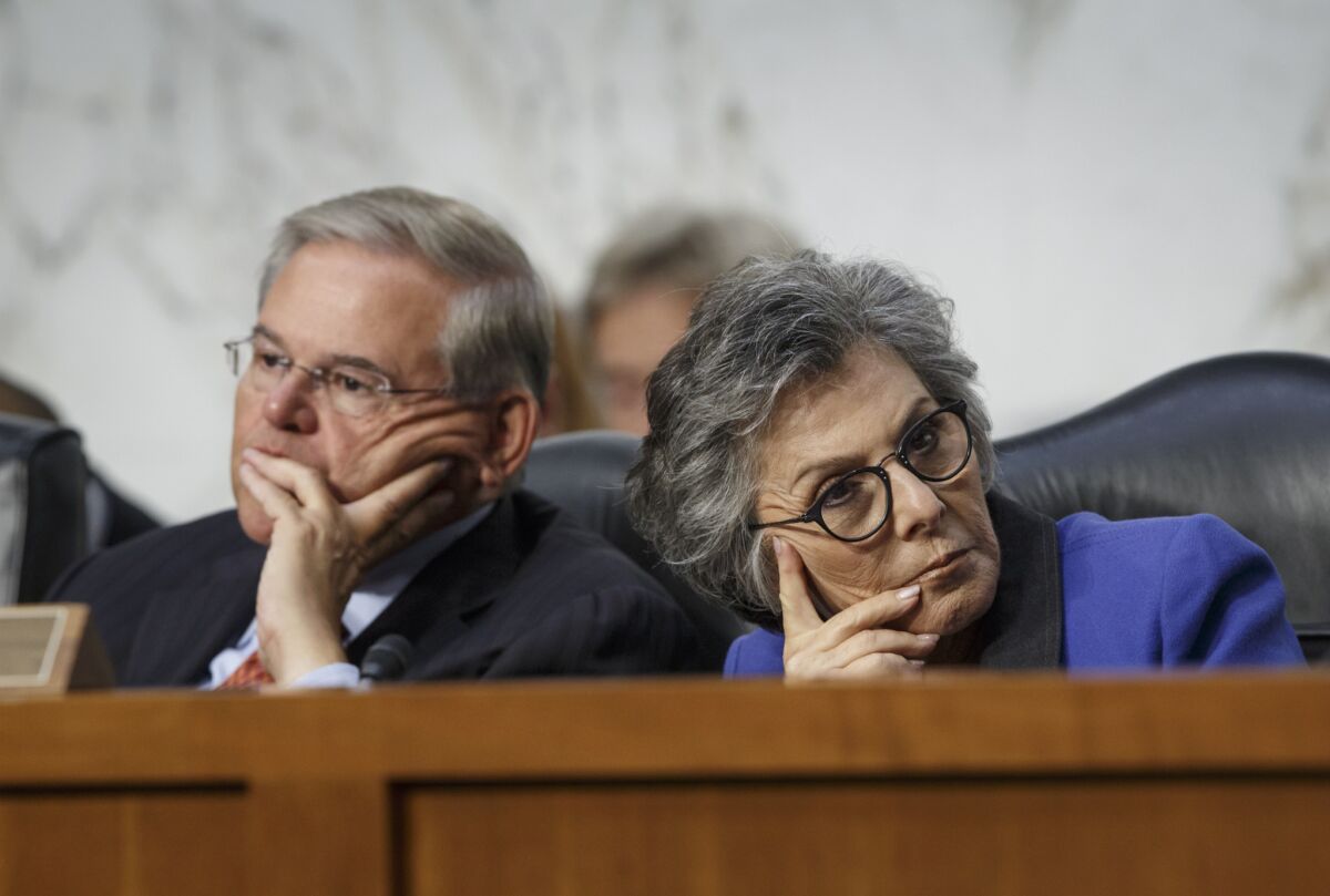 Senate Foreign Relations Chairman Robert Menendez (D-N.J.), left, and Sen. Barbara Boxer (D-Calif.) listen as Secretary of State John Kerry testifies on Capitol Hill about bolstering President Obama's strategy to combat Islamic State extremists.