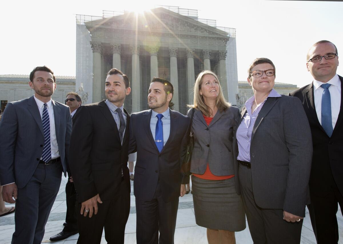 The plaintiffs in the California Prop. 8 case stand before the Supreme Court.