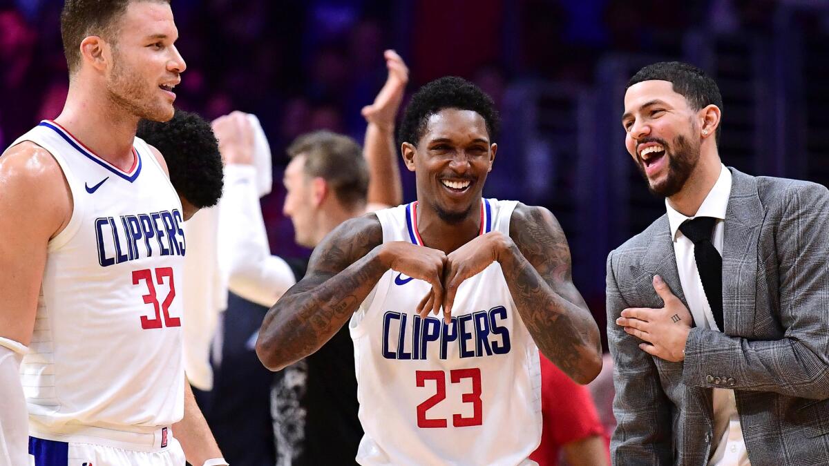 Lou Williams (23) celebrates with teammates Blake Griffin (32) and Austin Rivers during a 113-102 victory over the Rockets on MLK Day.