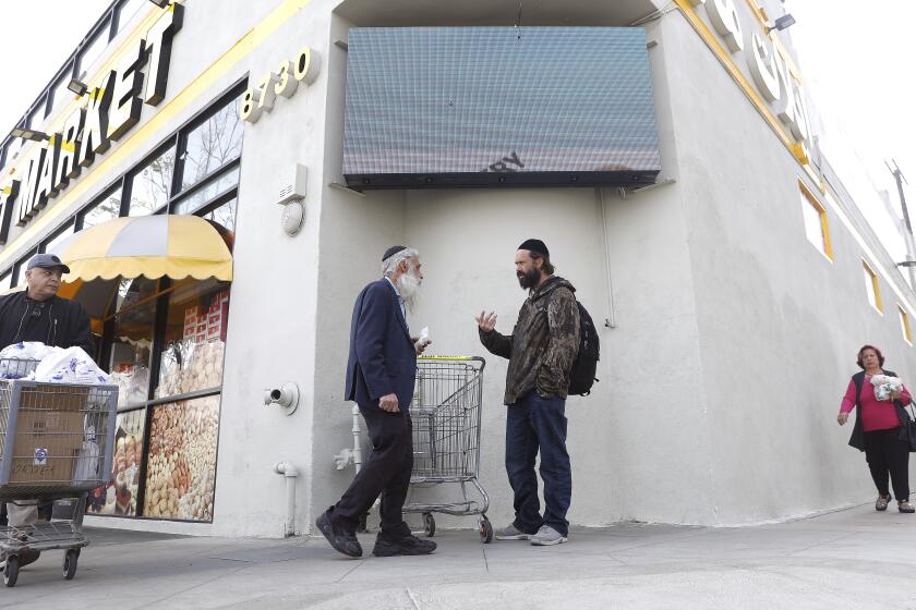LOS ANGELES-CA-FEBRUARY 17, 2023: People pass by Elat Market along Pico Boulevard in the Pico-Robertson area of Los Angeles on Thursday, February 17, 2023, where police have had more presence after the recent shootings of two Jewish men. (Christina House / Los Angeles Times)