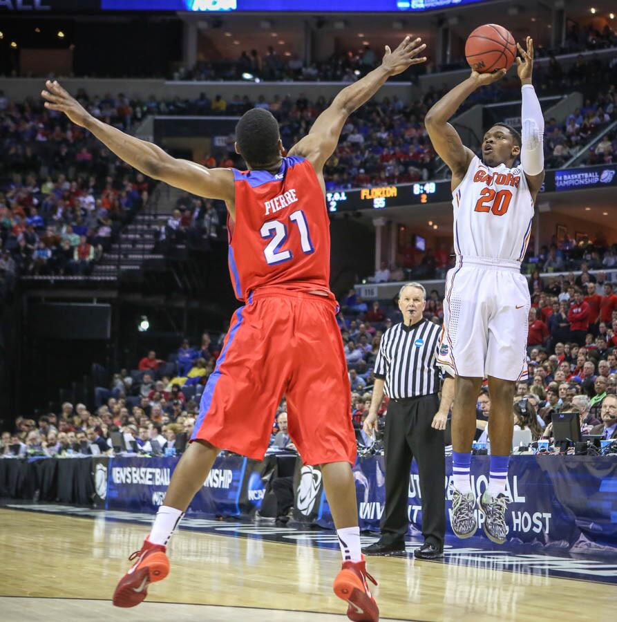 Florida's Michael Frazier II (20) goes up for a three point shot during second half action of an NCAA Elite 8 southern regional final against Dayton at the FedEx Forum in Memphis, TN on Saturday, March 29, 2014. (Joshua C. Cruey/Orlando Sentinel)