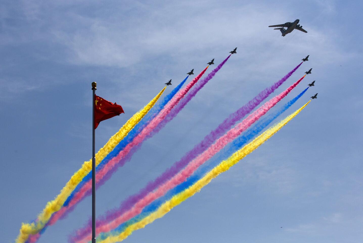 A KJ-2000 airborne early warning and control system leads J-10 fighter jets past a national flag during a military parade at Tiananmen Square in Beijing on Sept. 3, 2015, to mark the 70th anniversary of victory over Japan and the end of World War II.