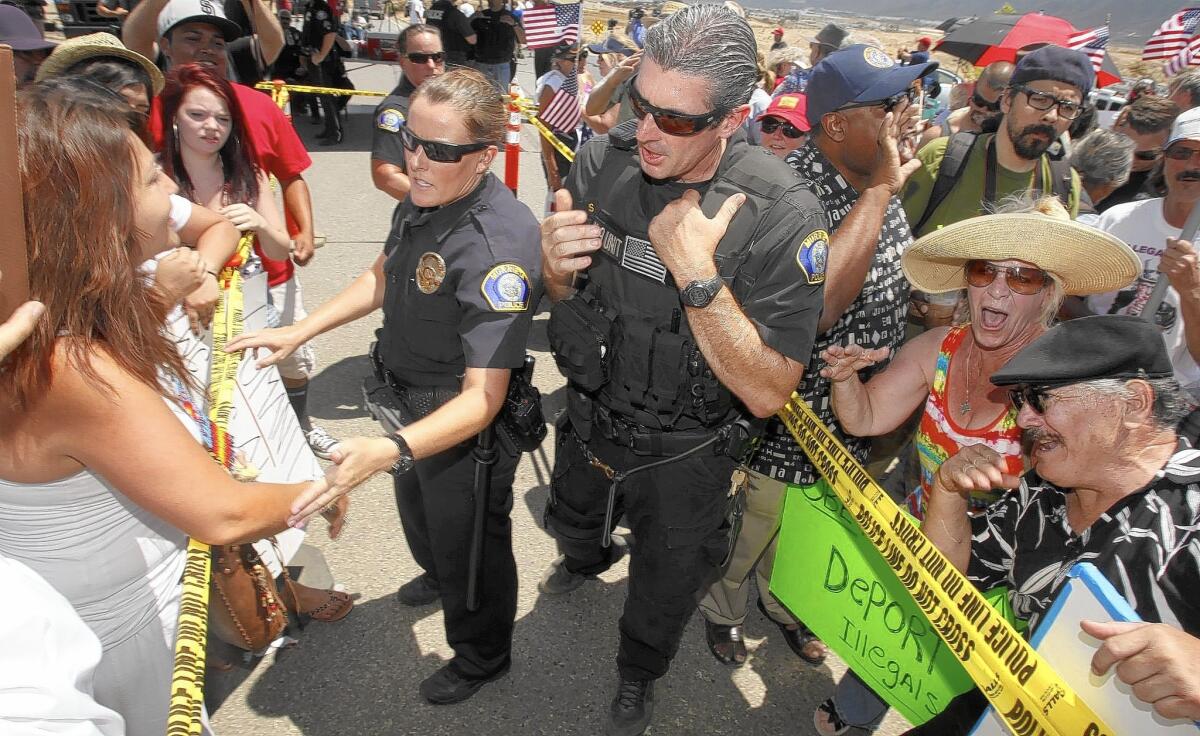 Crowds of protesters gather in front of the U.S. Border Patrol station in Murrieta in July, 2014, when protests forced away buses carrying immigrants apprehended at the Texas border.