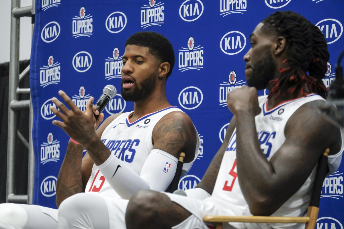 Clippers forward Paul George answers a reporter's question during media day on Sunday.
