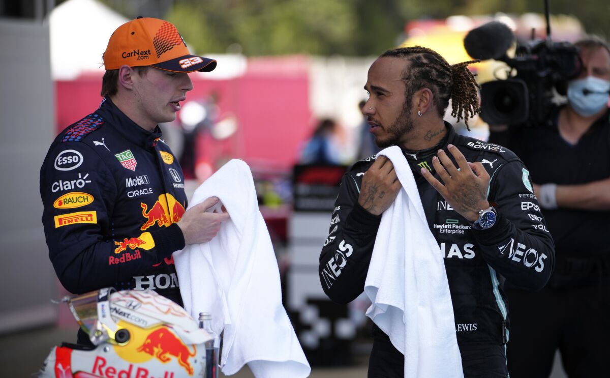 Lewis Hamilton, right, talks with Max Verstappen.