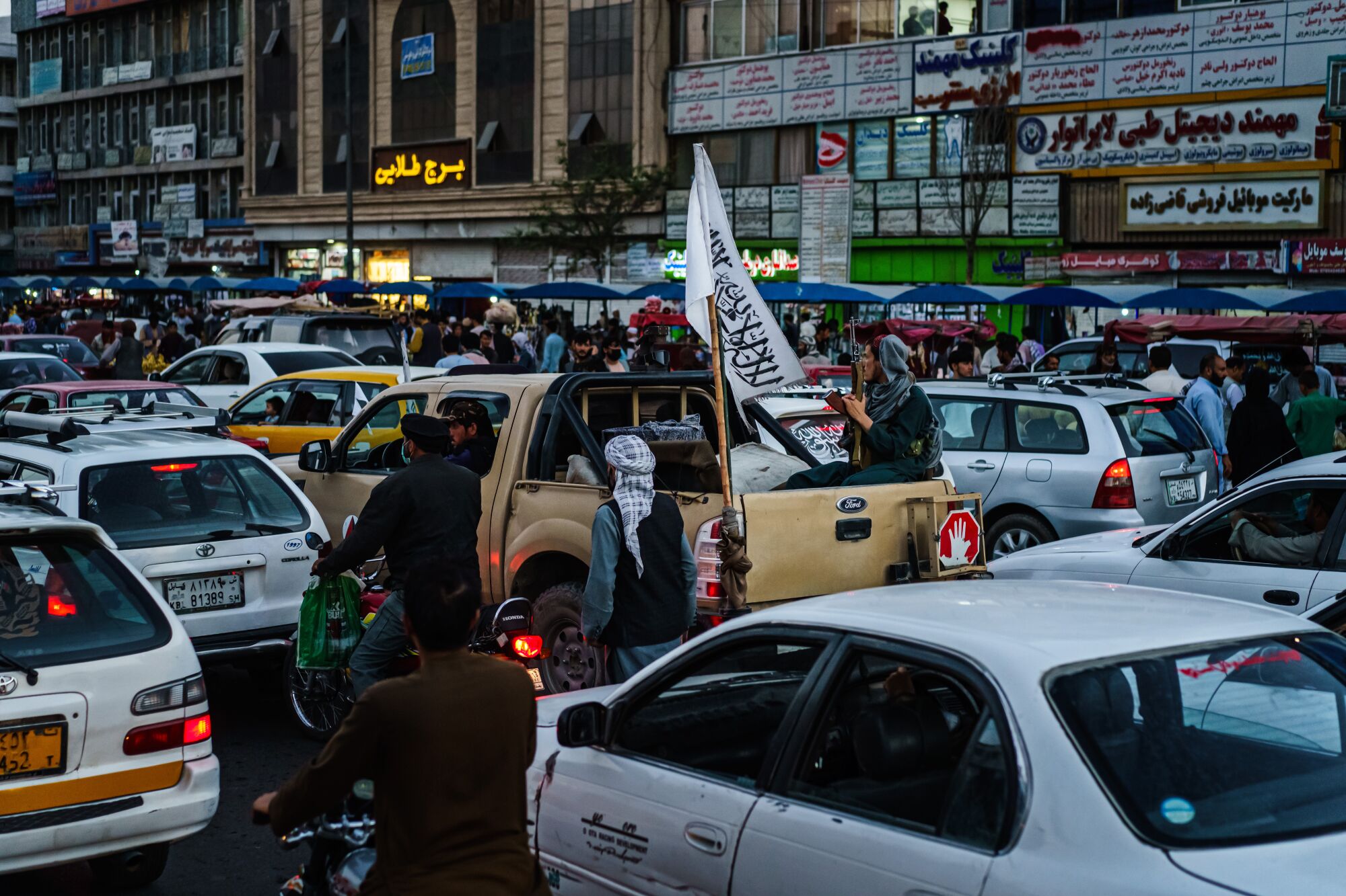 A Taliban patrol is stuck in rush hour traffic in downtown Kabul