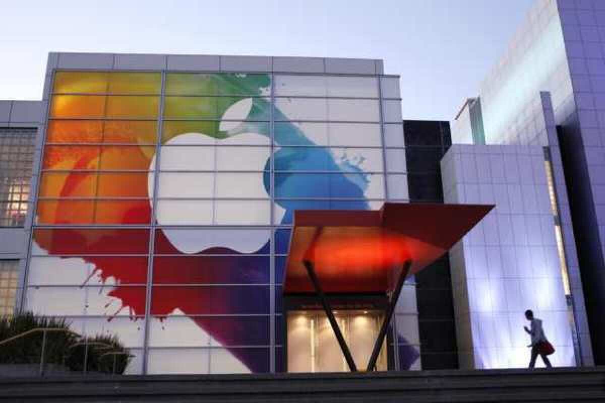 An Apple logo hangs above the entrance of Yerba Buena Center for Arts in San Francisco. The company is expected to unveil its newest iPhone on Wednesday.