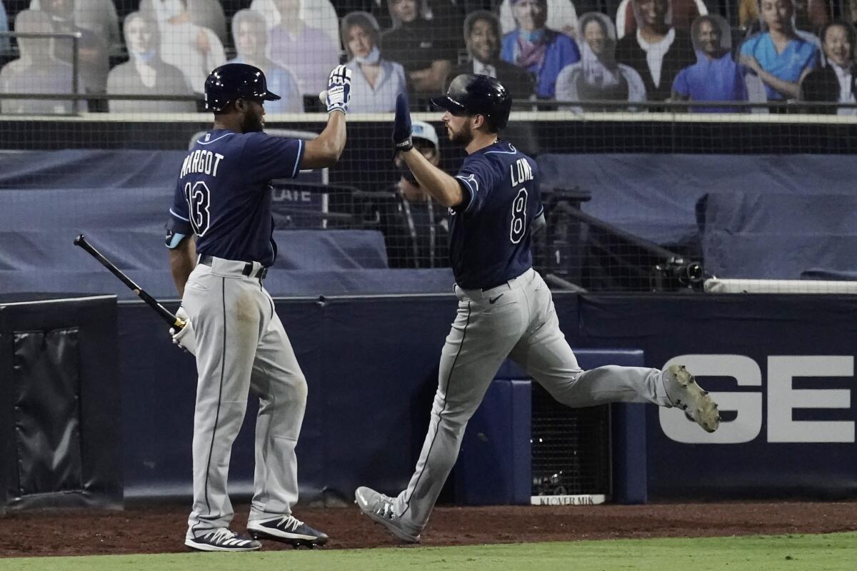 Tampa Bay Rays' Brandon Lowe celebrates with teammate Manuel Margot.