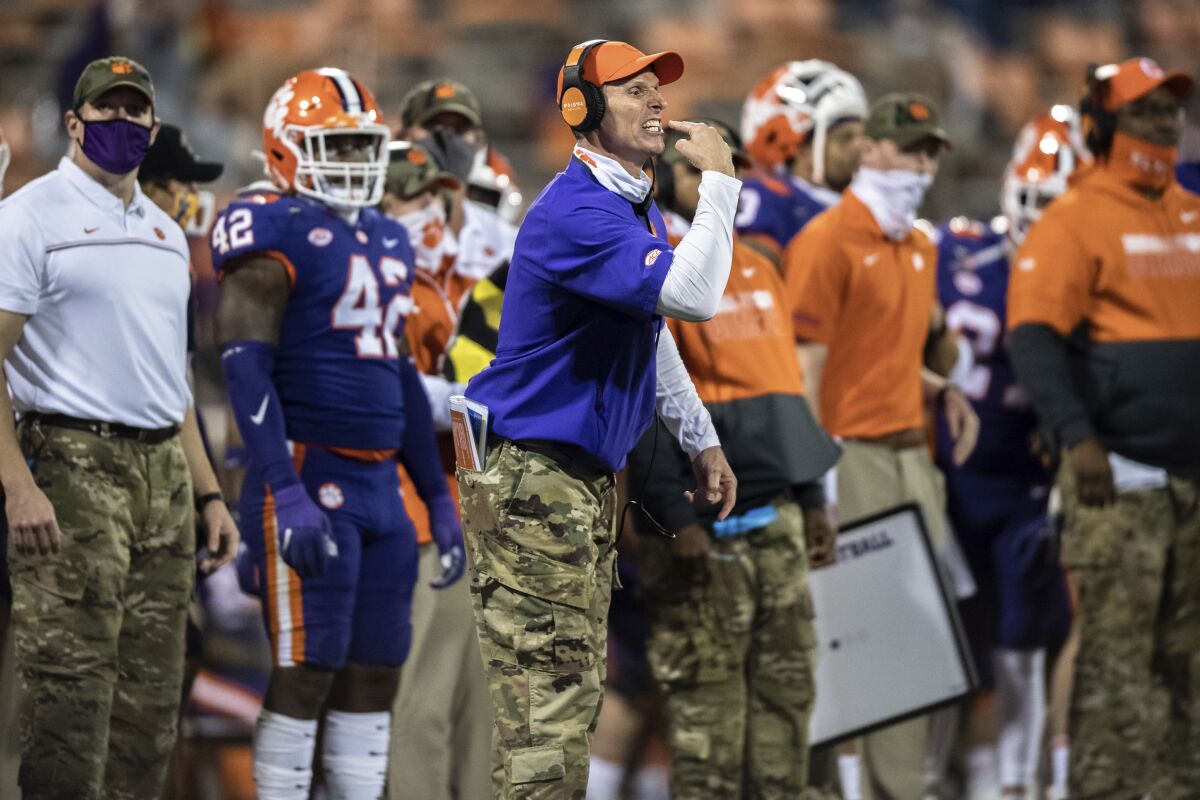 FILE -Clemson defensive coordinator Brent Venables, center, speaks to his players during the fourth quarter of an NCAA college football game against Pittsburgh in Clemson, S.C., Saturday, Nov. 28, 2020. A person with knowledge of the situation tells The Associated Press that Oklahoma is targeting Clemson defensive coordinator Brent Venables to be its new head coach. (Ken Ruinard/The Independent-Mail via AP, Pool, File)