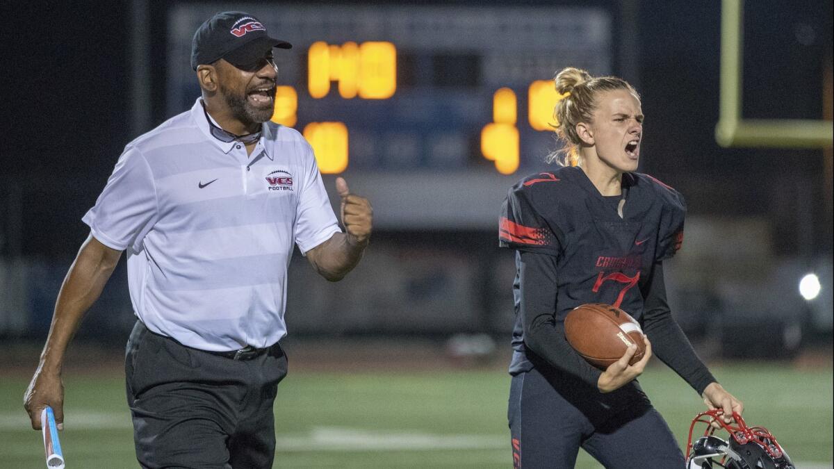 Former USC running backs coach Todd McNair, now an offensive line coach at Village Christian, cheers after a third-down stop late in the second quarter in Burbank on Friday.