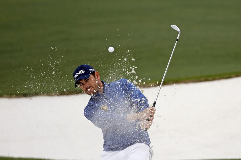 Louis Oosthuizen chips out of a bunker at the Masters on April 10.