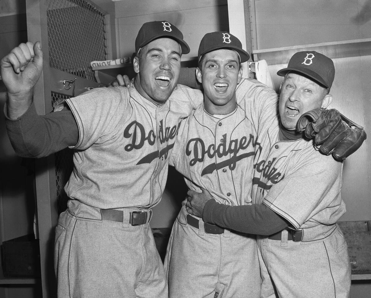Dodgers manager Charley Dressen (right) hugs Carl Erskine, center, and Duke Snider after the Game 5 victory.