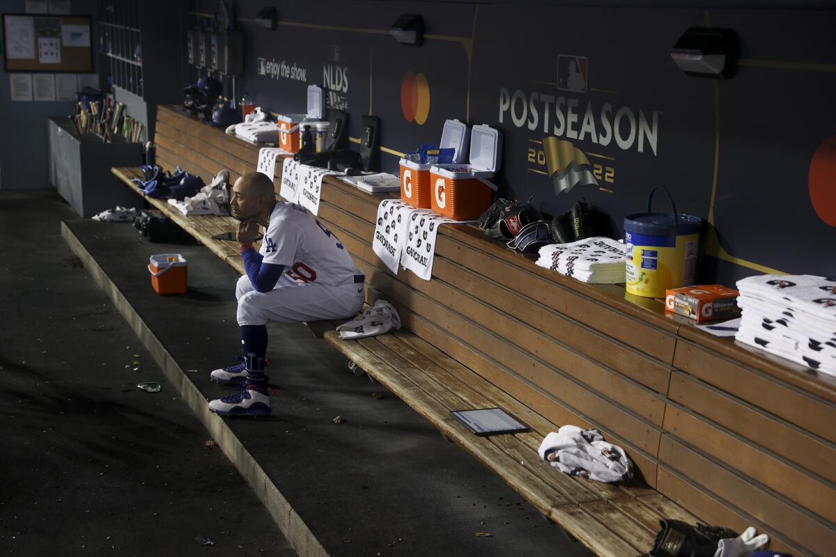 Dodgers right fielder Mookie Betts sits alone on the bench during Game 2.