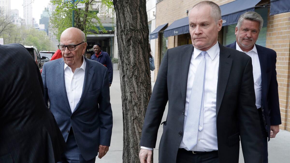 Rupert Murdoch, left, leaves a Manhattan restaurant on Monday with Fox News co-presidents Jack Abernethy and Bill Shine. Last week, 21st Century Fox fired the network's biggest star, Bill O'Reilly, following an investigation into sexual harassment allegations.