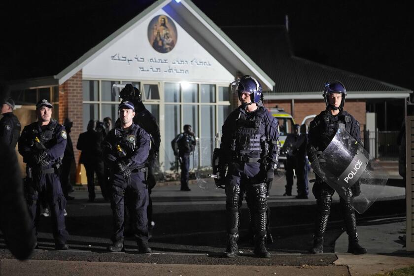 FILE - Security officers stand guard outside Orthodox Assyrian church in Sydney, Australia, April 15, 2024. Four teenagers plotted to buy guns and attack Jewish people days after a bishop was stabbed in a Sydney church, according to police documents cited in news reports on Monday, April 29, 2024. (AP Photo/Mark Baker, File)