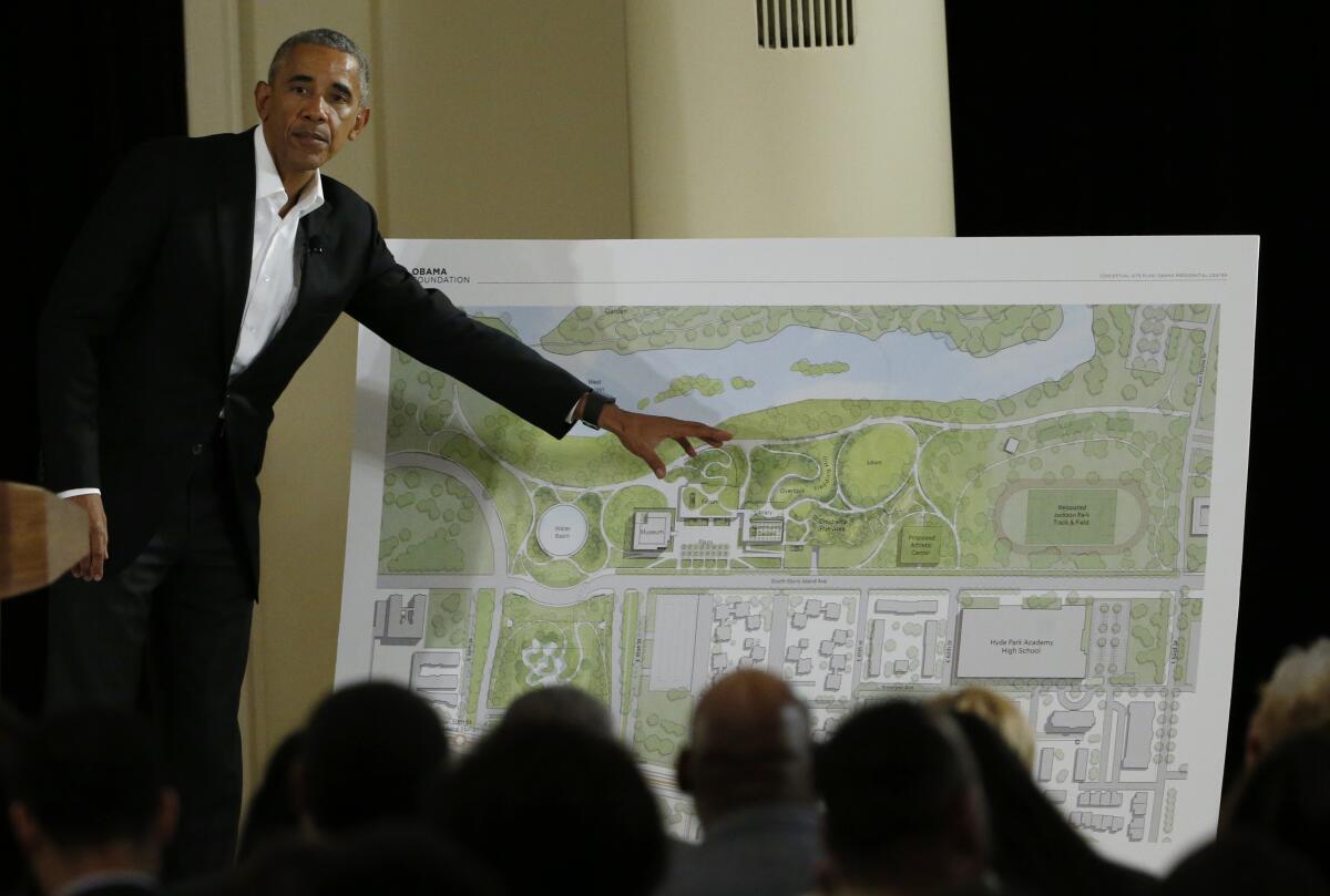 Former President Obama points to a rendering for his lakefront presidential center.