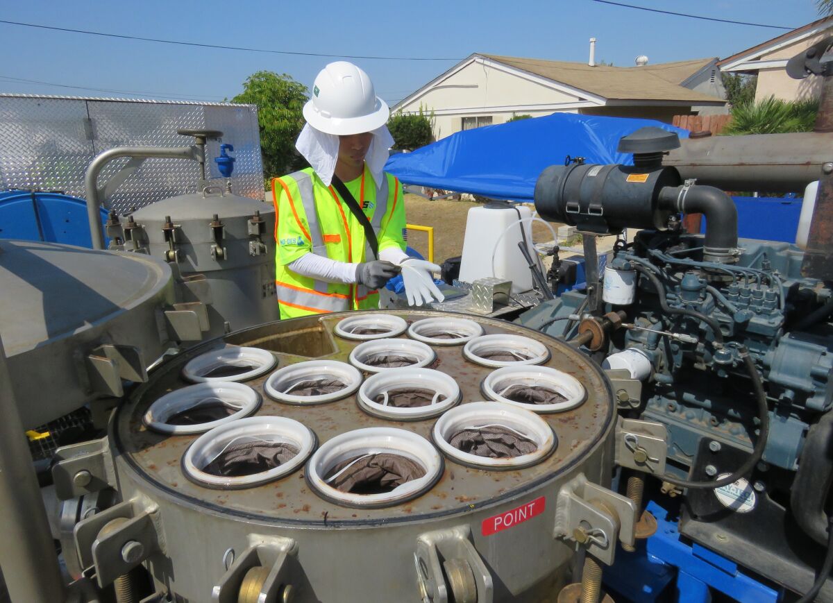 A Sweetwater Authority contractor's employee prepares to change the filters that captured sediments as part of a process to flush out pipelines.