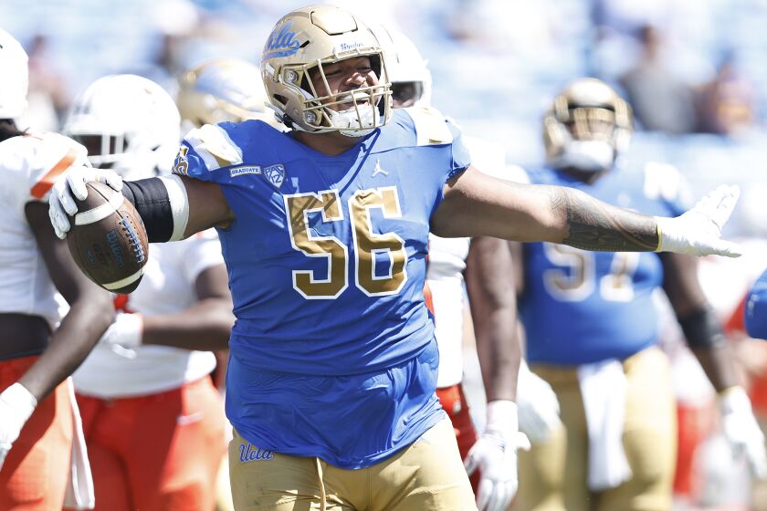 Atonio Mafi #56 of the UCLA Bruins celebrates after recovering a fumble against the Bowling Green Falcons