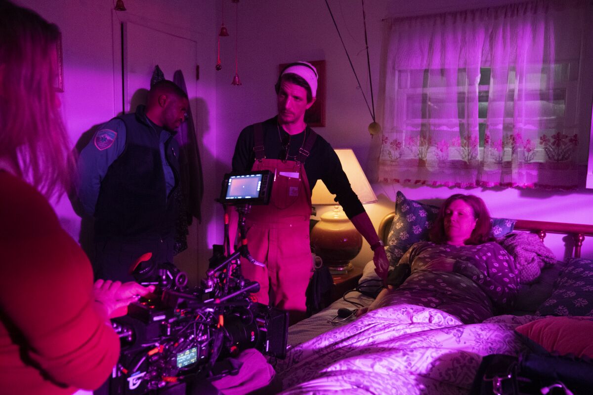 Director pointing at woman on bed