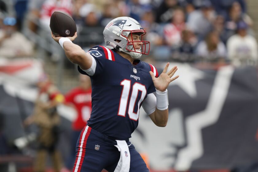 New England Patriots quarterback Mac Jones winds up to pass in the first half of an NFL football game against the Baltimore Ravens, Sunday, Sept. 25, 2022, in Foxborough, Mass. (AP Photo/Paul Connors)