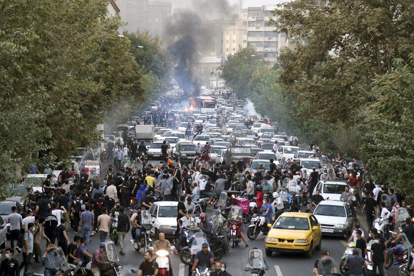 FILE - In this photo taken by an individual not employed by the Associated Press and obtained by the AP outside Iran, protesters chant slogans during a protest over the death of a woman who was detained by the morality police, in downtown Tehran, Iran, Sept. 21, 2022. (AP Photo, File)