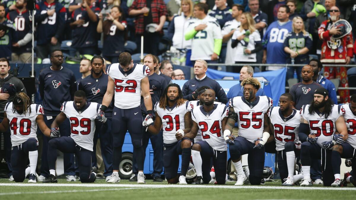 Houston Texans teammates join in solidarity during the anthem before a game this year.