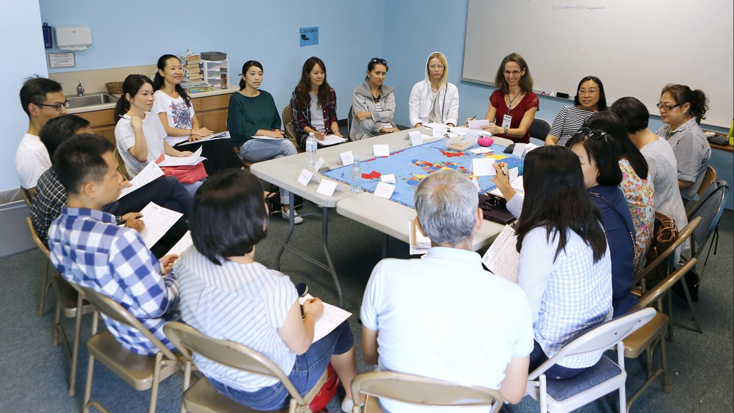 Michelle Estrick, right of top center, teaches intermediate English as a Second Language (ESL) to students from a variety of countries at Voyagers Bible Church in Irvine on Sept. 15, 2017. About 80 students showed up to learn English, from beginning to advanced.