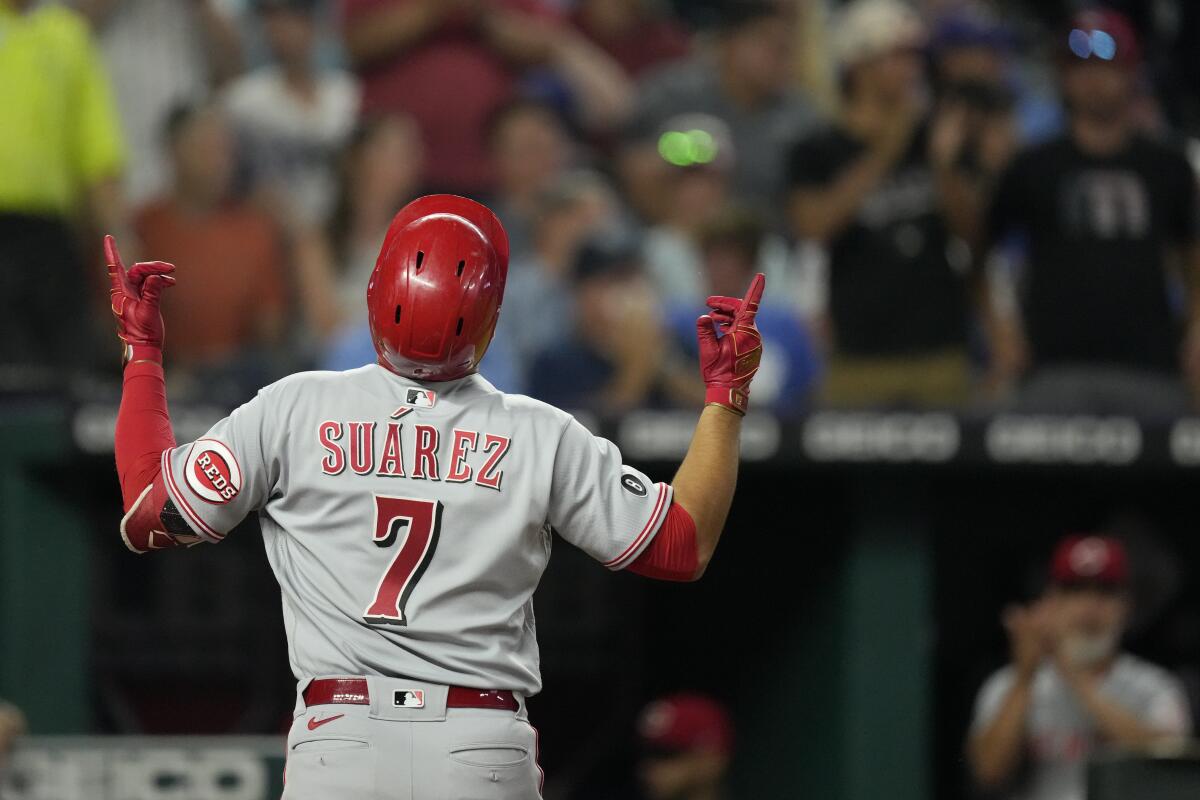Cincinnati Reds' Eugenio Suarez celebrates after hitting a three-run home run during the seventh inning of a baseball game against the Kansas City Royals Monday, July 5, 2021, in Kansas City, Mo. (AP Photo/Charlie Riedel)