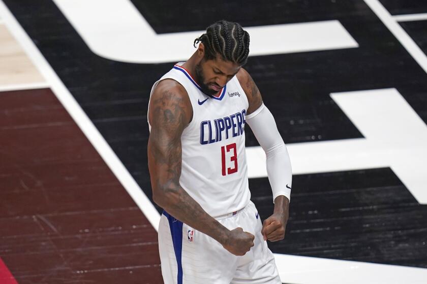 Los Angeles Clippers guard Paul George (13) flexes his muscles after scoring against the Utah Jazz during the first half of Game 5 of a second-round NBA basketball playoff series Wednesday, June 16, 2021, in Salt Lake City. (AP Photo/Rick Bowmer)