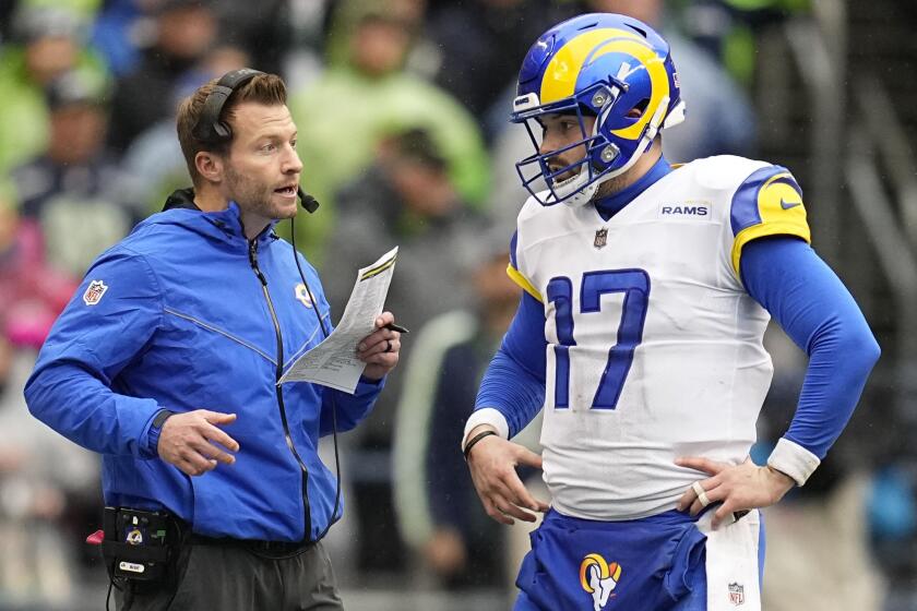 Los Angeles Rams head coach Sean McVay, left, talks to quarterback Baker Mayfield.