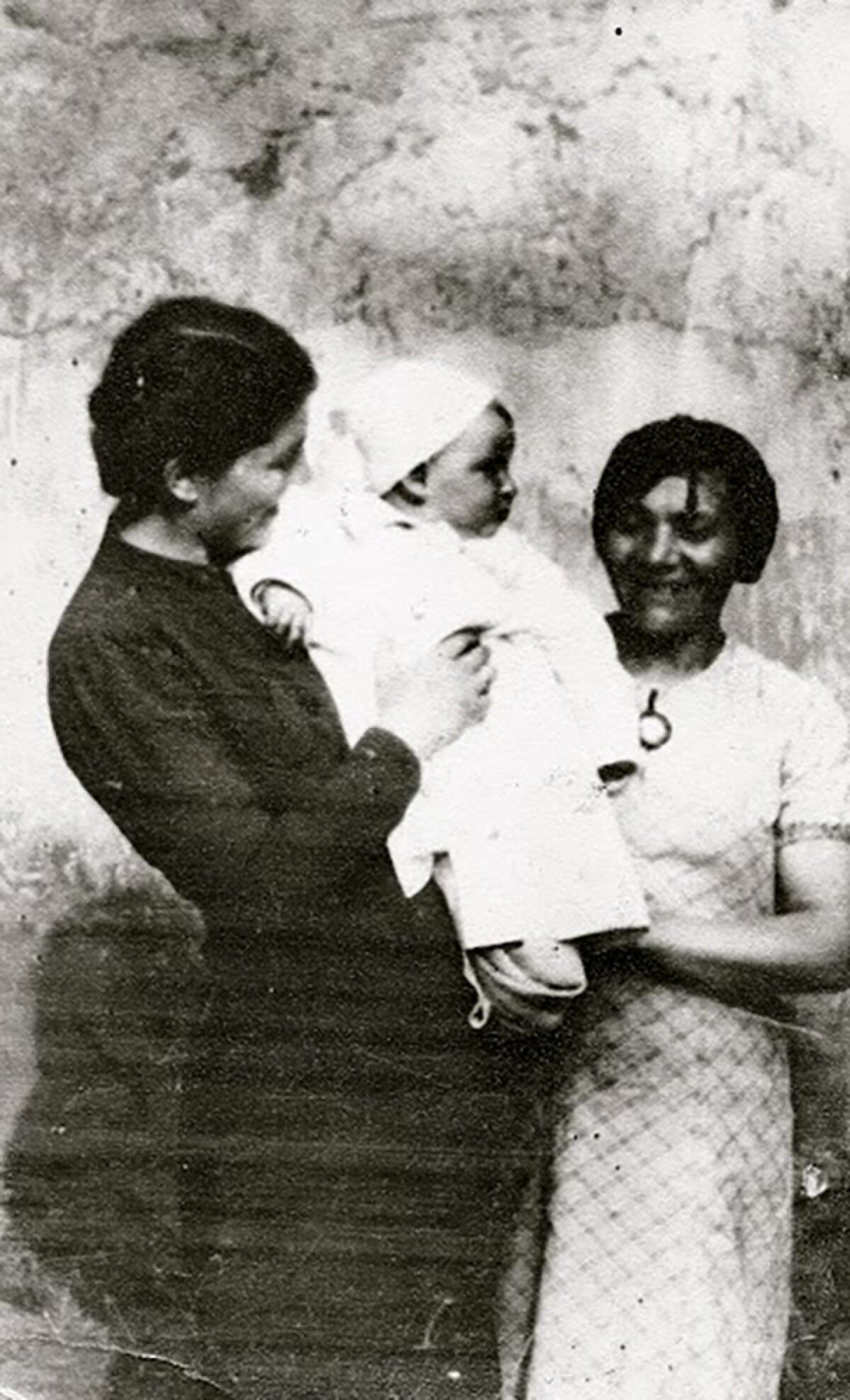 Paula Gerson holding baby with an unidentified woman